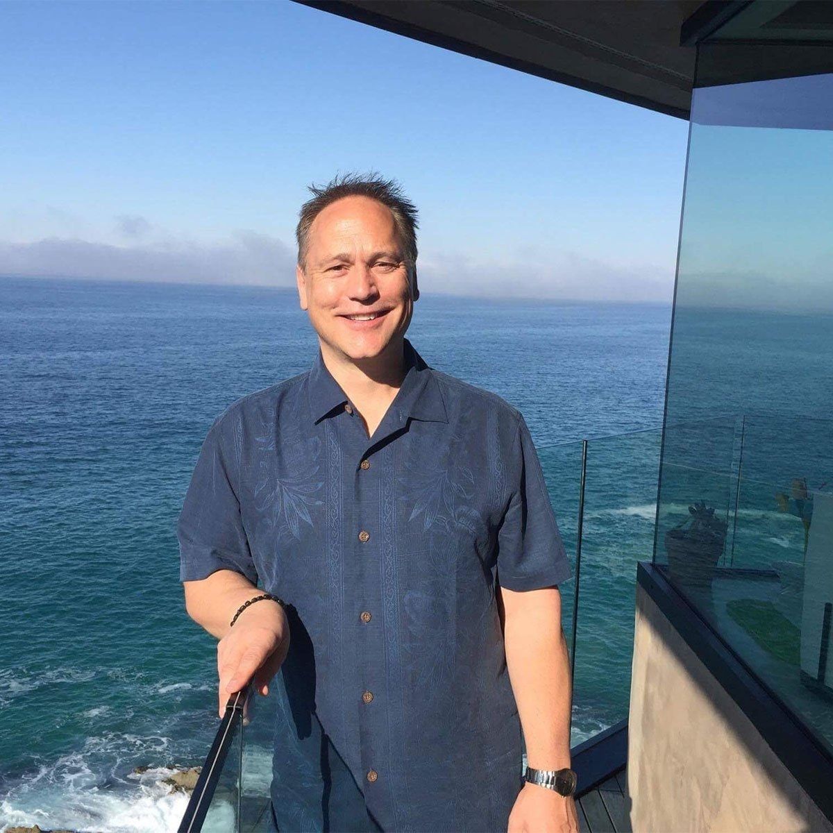 Trevor on a balcony overlooking the ocean