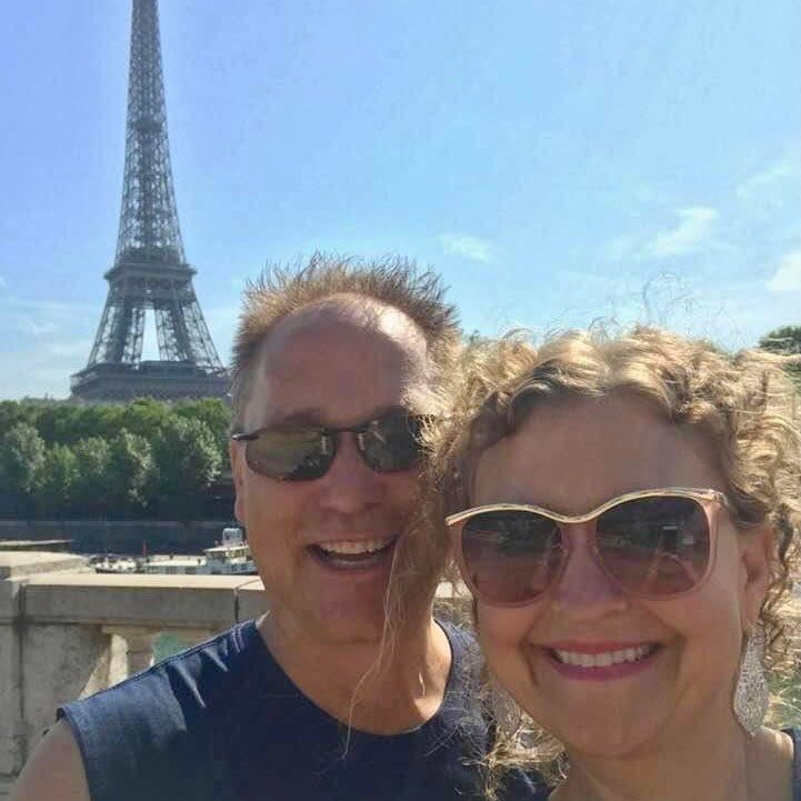 Trevor and his wife in front of the Eiffel Tower