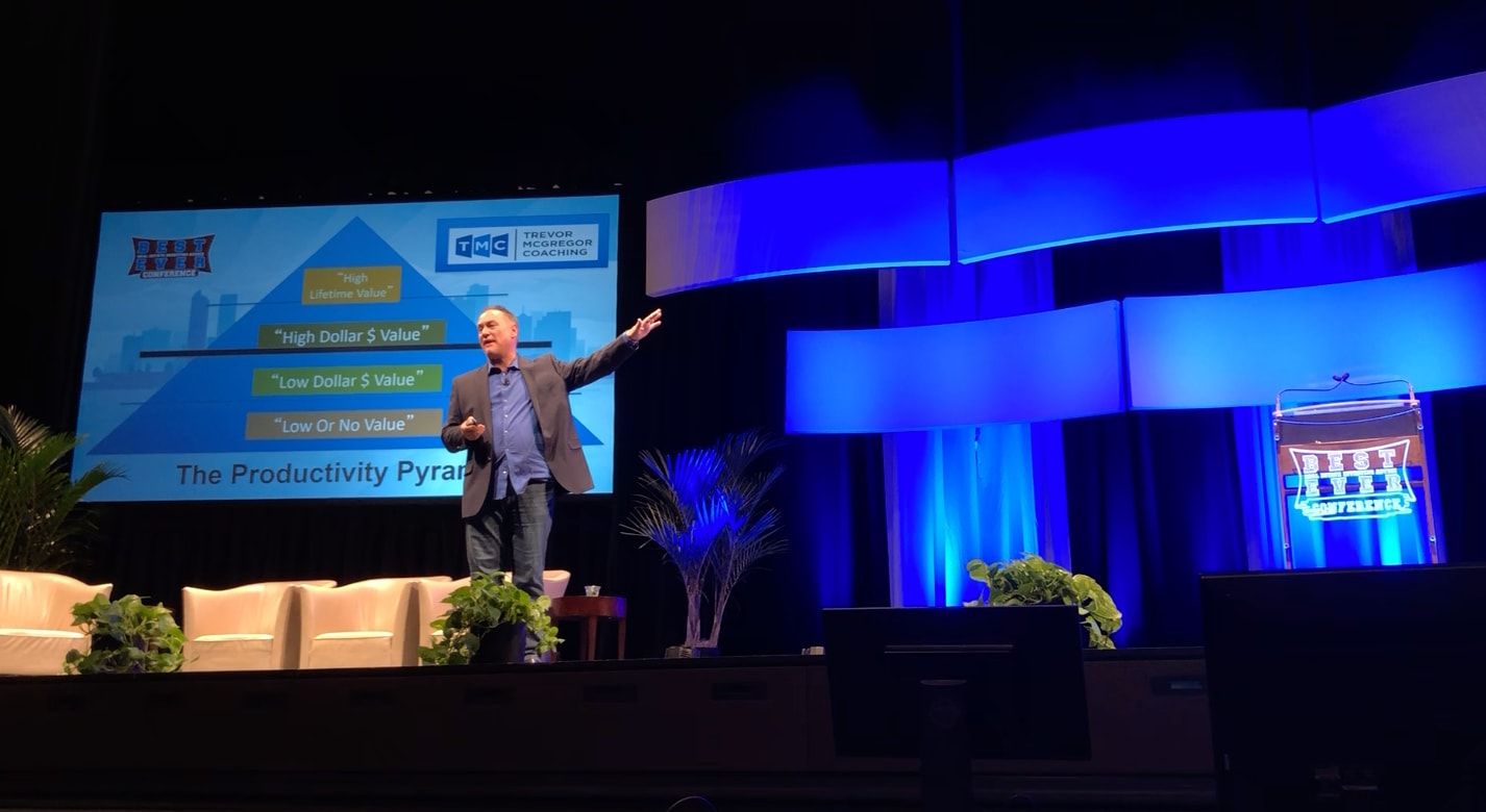 Trevor McGregor presenting on stage to a conference audience